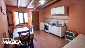 a kitchen with a table and a kitchen with a stove at Glamping en Valle Grande in Valle Grande