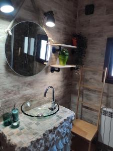 ein Bad mit einem Waschbecken und einem Spiegel in der Unterkunft Casa Rural Los Agüelos in Mazuecos
