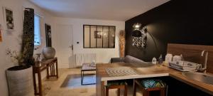 a kitchen and living room with a table and a sink at LE PATIO / les suites romantiques du grenier à sel in Honfleur +15 photos