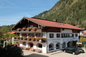 a large building with flowers on the balconies of it at Gästehaus Angerer in Reit im Winkl