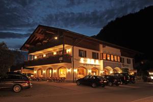 a building with cars parked in front of it at night at Gästehaus Angerer in Reit im Winkl