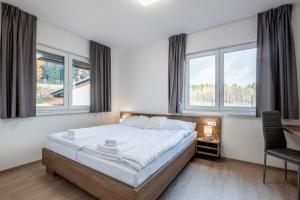Postel nebo postele na pokoji v ubytování Apartmány ZaBukem