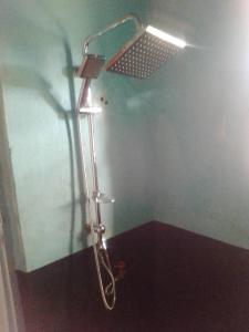 a shower in a bathroom with a shower head at Kabatoro Guest House in Kabatoro
