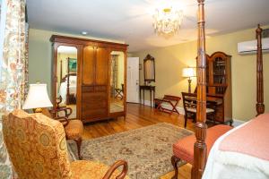 a bedroom with a bed and a living room at Kehoe House, Historic Inns of Savannah Collection in Savannah