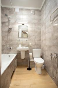 a bathroom with a toilet and a sink and a shower at Квартира в центре на соборной apartment in sobornaya st in Mykolaiv