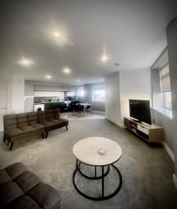 a living room with a couch and a table at Seaview Luxury Apartments in Redcar