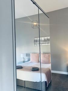 a bedroom with a bed with a glass wall at Seaview Luxury Apartments in Redcar