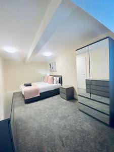 a bedroom with a bed and a large mirror at Seaview Luxury Apartments in Redcar
