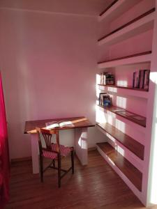 a desk in a room with a book shelf at Appartamento con vista a Torre Pellice in Torre Pellice