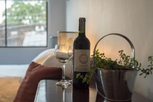 a bottle of wine and a glass on a table at El Caracol in Popayan