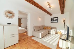- un salon avec un canapé et une télévision dans l'établissement Schei Residence, à Braşov