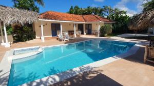 a swimming pool in front of a house at Casa Giò in Las Terrenas