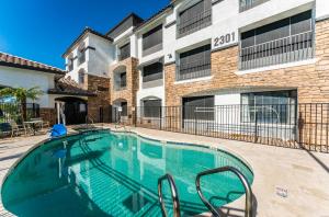 a swimming pool in front of a building at Tempe Studio One bedroom 1st floor condos with construction discounts in Tempe