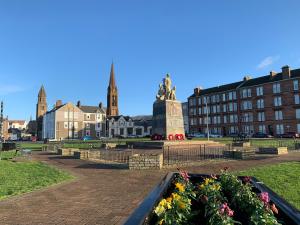 a park with a statue in the middle of a city at Seaview one bedroom apartment in centre of Largs in Largs