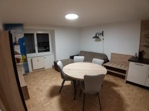 a living room with a table and chairs and a couch at Modern Apartment, Full Kitchen, for 6 in Gmunden