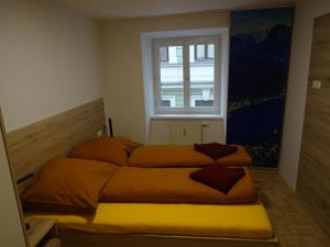 a bedroom with two beds in front of a window at Modern Apartment, Full Kitchen, for 6 in Gmunden