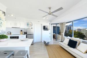 a living room filled with furniture and a kitchen at Centrepoint Apartments Caloundra in Caloundra