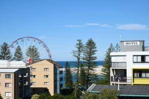 
a large building with a clock on top of it at Centrepoint Apartments Caloundra in Caloundra

