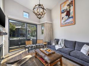 a living room with a couch and a table at Chalet Nanook Akuna 2 in Thredbo