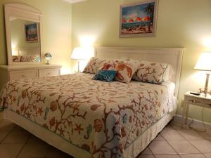 a bedroom with a bed with two lamps and two tables at A Place at the Beach 406 in Myrtle Beach +31 photos
