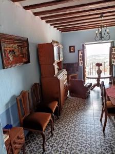 a living room with chairs and a table and a window at Magnífica casa de pueblo con todas las comodidades in Moratalla