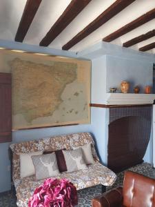 a couch in a room with a map on the wall at Magnífica casa de pueblo con todas las comodidades in Moratalla