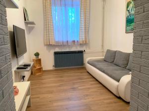 a living room with a couch and a television at Crystal Lakes Apartment in Plitvička Jezera