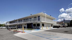 a large white building with a parking lot at Motel 6-Woods Cross, UT - Salt Lake City - North in Woods Cross