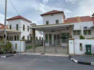 a white house with green windows and a driveway at VISTANA INDAH HOMESTAY in Alor Setar