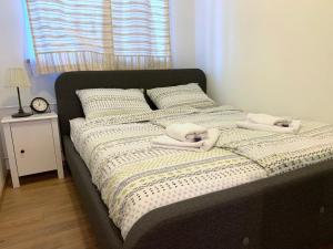 a bed with two towels on top of it at Crystal Lakes Apartment in Plitvička Jezera