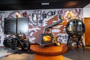 una motocicleta estacionada junto a una pared de ladrillo con chimenea en RED DEER Hotel, en Brezno