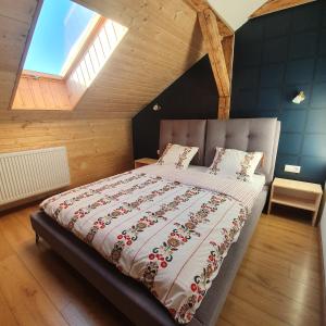 a bedroom with a large bed in a attic at RED DEER Hotel in Brezno
