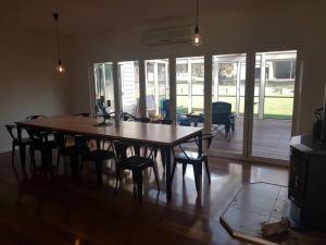 a dining room with a wooden table and chairs at Woodside Ranch Luxury Farmstay in Woodside