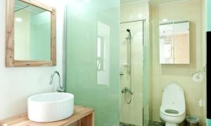 a bathroom with a sink and a toilet at Oceantree House in Seogwipo