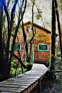a wooden walkway in front of a house at Casa Molino de Chiloé in Castro