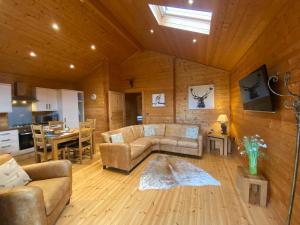 a living room with a couch and a table at Hollybush Lodges in Leigh upon Mendip