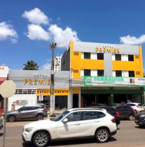 a parking lot with cars parked in front of a building at Hotel Premier in Brasilia
