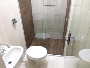 a bathroom with a shower and a toilet and a sink at Hotel Premier in Brasília