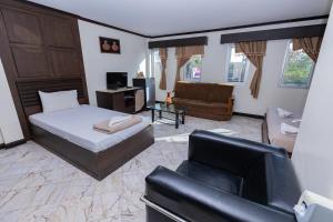 a living room with a bed and a couch at Mix Hotel in Ban Hua Thale +51 photos