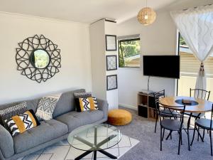 a living room with a couch and a table at Koru Havenz in Picton