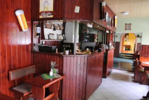 a bar in a restaurant with wood paneling at Penzion Haus Regrus in Jáchymov