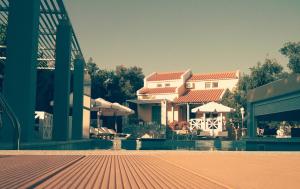 a house with a swimming pool next to a building at Sea Sun in Plomari
