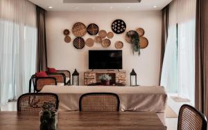 a dining room with a table with chairs and a tv at Pranatarn Pool Villa Mid-Summer Night in Ban Bo Kaeo +9 photos