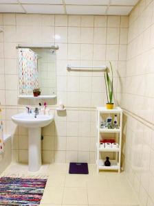 a bathroom with a sink and a mirror at LADIES ONLY-AnaRuby Backpackers - Metro Station Mashreq in Dubai