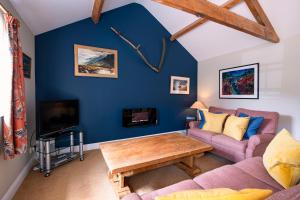 a living room with a couch and a table at Alwent Mill in Winston