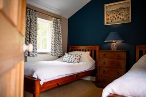 a small bedroom with a bed and a window at Alwent Mill in Winston