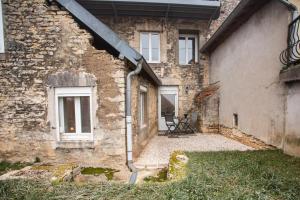 a stone house with a staircase leading up to it at LA MADELEINE -GARE - CENTRE-VILLE - Home-One in Saint-Vit