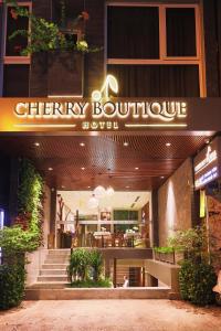 a city boutique hotel with a sign on the front of it at CHERRY BOUTIQUE HOTEL in Ho Chi Minh City