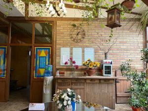 a kitchen with a counter with a refrigerator at Orbita hotel Shymkent in Shymkent