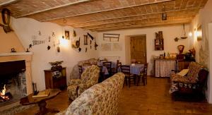 a living room with a fireplace and a table and chairs at Dimora Barbolani in Lettopalena